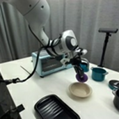 Robot holding a purple plush toy over a bowl